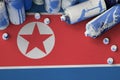 North Korea flag and few used aerosol spray cans for graffiti painting. Street art culture concept
