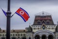 The North Korean flag and the building of Vladivostok railway station in Primorsky krai, Russia