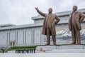 North Korean people bowing in front of Kim Il Sung and Kim Jong Il statues in Mansudae Grand Monument, Pyongyang, North Korea Royalty Free Stock Photo