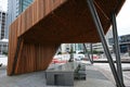 Modern wood North Kumutoto Pavilion with strips on folded plates and steel posts on plaza in Wellington CBD, New Zealand