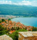 North macedonia. Ohrid. Different buildings and houses with red roofs on lake shore on mountains background Royalty Free Stock Photo