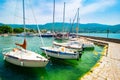 North macedonia. Ohrid. Different sail boats beside dock on ohrid lake with mountaines on background Royalty Free Stock Photo