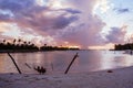 North Male Atoll, Maldives - November 23, 2019: A happy adult couple relaxes in a hammock over the water at a resort in the