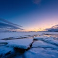 North, Norway. Winter landscape during sunset. Bright sky. Ice and snow on the shore. Reflections on the ice surface. Snowy winter Royalty Free Stock Photo