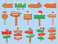 North pole signs. Christmas wooden street signboad with snow. Arrow signpost direction to Santa workshop. Winter holiday