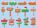 North pole signs. Christmas wooden street signboad with snow. Arrow signpost direction to Santa workshop. Winter holiday toy shop