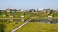 North Russian village. Summer day, river, old cottages on coast.