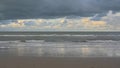 North sea beach with dark clouds reflecting in wet sand Royalty Free Stock Photo