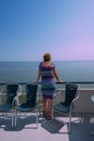 North Sea Netherlands 26-july-2018 Woman stands at the railing of a ship that sails on a calm ocean in summer time, and looks out Royalty Free Stock Photo