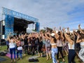 People wave hands in the arm by stage at Wanderlust MC Yogi Yoga Class