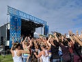 People wave hands in the arm by stage at Wanderlust MC Yogi Yoga Class