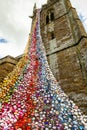 North tower of All Saints church in Middleton Cheney decorated with crochet flower and animals