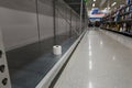 NORTH VANCOUVER, BC, CANADA - MAR 19, 2020: An empty shelf with a single roll of toilet paper at a supermarket as panic