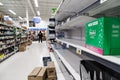 NORTH VANCOUVER, BC, CANADA - MAR 19, 2020: A security guard watches over shoppers at a local supermarket stocking up on Royalty Free Stock Photo