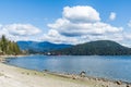 NORTH VANCOUVER, CANADA - APRIL 11, 2021: Panorama landscape photo Indian Arm with red cargo ship