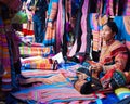 North Vietnamese woman in colorful native clothing sells similar