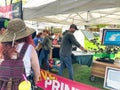 Couple watches live shirt printing at Holland Tulip Festival Artisan Market