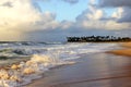 Northeastern Brazilian beach at dusk with cloudy sky and white waves..