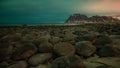 The norther lighfs over the cloud on a beach full of rocks