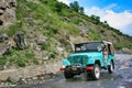 Northern Area, Pakistan - August 12, 2011: Jeep crossing over damaged road of Northern Area, Pakistan