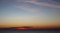 Colorful cloud extravaganza before sunset over the sea.