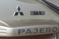 Mitsubishi Pajero logo on back of beige SUV Royalty Free Stock Photo