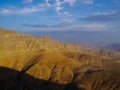 Northern flank of Jebel al Harim mountain with a view of the closed military road leading towards United Arab Emirates in evening