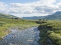 Northern landscape, tundra in Swedish Lapland with wooden cottages of STF Duottar tourist hut, blue artic river and lake