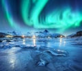Northern lights above snowy mountains, frozen sea coast Royalty Free Stock Photo