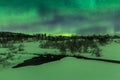 Northern lights above a water stream in a winter landscape. Royalty Free Stock Photo