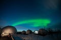 Northern Lights Also Known As Aurora, Borealis Or Polar Lights At Cold Night Over Igloo Village. Beautiful Night Photo