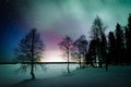 Northern lights Aurora Borealis activity over the lake in winter Finland