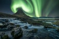 Northern lights/Aurora borealis over the famous mountain Kirkjufell and kirkjufellsfoss waterfall at night. Royalty Free Stock Photo