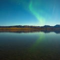 Northern lights and fall colors at calm lake Royalty Free Stock Photo