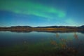 Northern lights and fall colors at calm lake Royalty Free Stock Photo