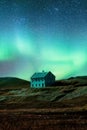 Northern lights glowing over abandoned house on hill in remote location at Iceland Royalty Free Stock Photo