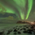 Northern lights in Lofoten islands, Norway. Green Aurora borealis. Starry sky with polar lights. Night winter landscape in night. Royalty Free Stock Photo