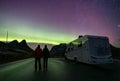 Northern lights and motorhome camper and couple in Trollstigen road, Norway Royalty Free Stock Photo