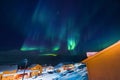 Northern lights in the mountains house of Svalbard, Longyearbyen city, Spitsbergen, Norway wallpaper Royalty Free Stock Photo