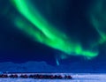 Northern lights in the mountains house of Svalbard, Longyearbyen city, Spitsbergen, Norway wallpaper Royalty Free Stock Photo