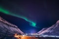 Northern lights in the mountains house of Svalbard, Longyearbyen city, Spitsbergen, Norway wallpaper Royalty Free Stock Photo