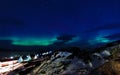 Northern lights over the Inuit village, fjord and mountains, nearby Nuuk city, Greenland