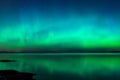 Northern lights over lake in finland Royalty Free Stock Photo