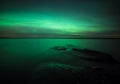 Northern lights over lake in finland Royalty Free Stock Photo