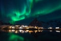 Northern lights over the mountain at sakrisoy rorbuer in winter season, Lofoten islands, Norway Royalty Free Stock Photo