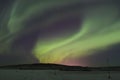 Northern lights over townlights Royalty Free Stock Photo