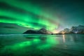 Northern Lights and sandy beach at starry winter night