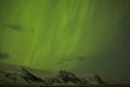 Northern lights with snowy mountains in the foreground Royalty Free Stock Photo