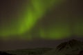 Northern lights with snowy mountains in the foreground Royalty Free Stock Photo