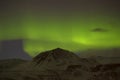 Northern lights with snowy mountains in the foreground Royalty Free Stock Photo